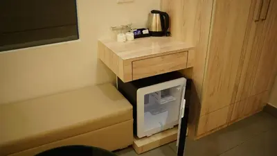 a small tv in a small room with a counter at VOX holiday in Palakkad