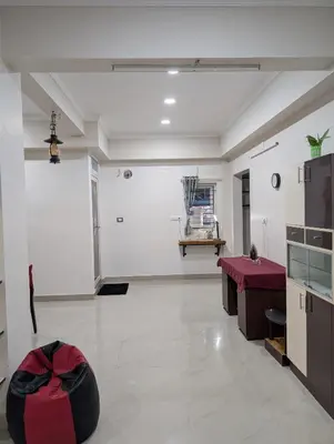 a large white room with a table and a counter at Eva's Homestay at Cherai in North Paravur