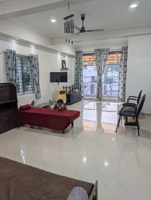 a child laying on a couch in a living room at Eva's Homestay at Cherai in North Paravur