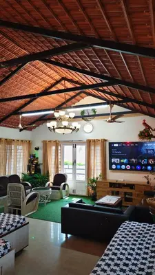 a large living room with a large tv and furniture at Steeva service apartment in Mysore