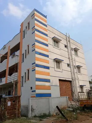 a building with colorful stripes on the side of it at Sona rooms in Coimbatore