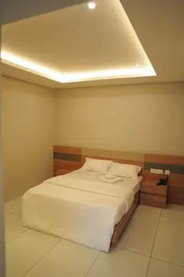 a bedroom with a large white bed in a room at Neom Inn in Wayanad