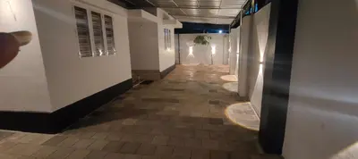 a hallway of a building with a person walking down it at Ivory Suites Meadows in Kozhikode
