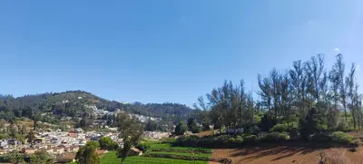 a view of a town on a hill at Jay bahadur Cottages and home stay in Ooty