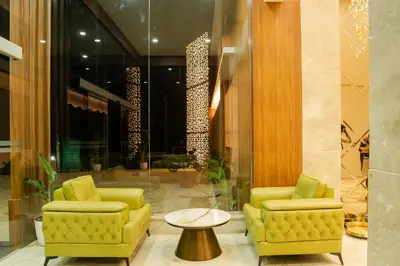 a lobby with two yellow chairs and a table at Chaliyar Resorts