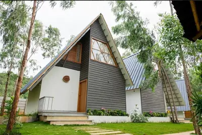 a small house with a gambrel roof at ivaana resorts mysore in Mysore