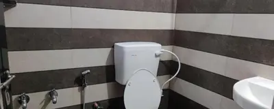 a bathroom with a toilet and a sink at hilldown cottage in Ooty