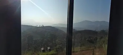 a view of a mountain view from a window at Spirit of the Wild Mountain Retreat in Attappādi