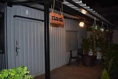 a garage with a door and a sign that says backyard at GUDU by Coexist in Mysore