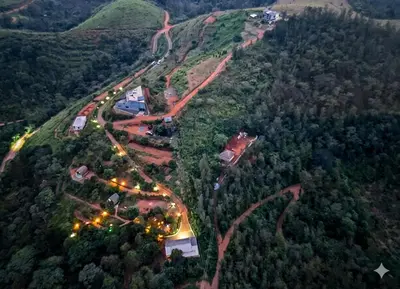 an overhead view of a mountain with roads and lights at Spirit of the Wild Mountain Retreat in Palakkad