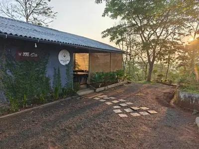 a blue building with a sign on the side of it at Spirit of the Wild Mountain Retreat in Palakkad