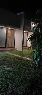a house at night with a lawn in front of it at Metta Heaven Farm Resort in Kodenchery