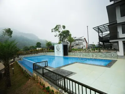 a large swimming pool next to a building at Ymoon Mountain Resort Wayanad in Koroth