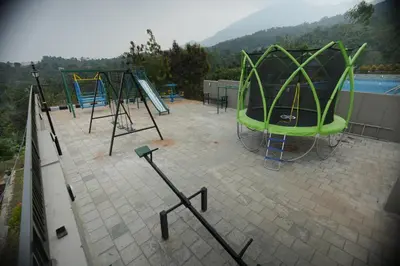 a group of playground equipment on top of a roof at Ymoon Mountain Resort Wayanad in Koroth
