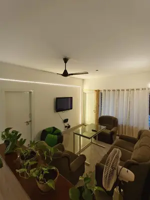 a living room with two couches and a table at Raviudaya-2bhk in Mysore