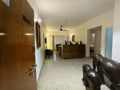 a living room with a door and a room with a bedroom at Raviudaya-2bhk in Mysore
