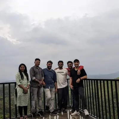 a group of people standing on top of a fence at Spirit of the Wild Mountain Retreat Attapadi in Attappādi