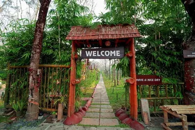 a gate with a welcome sign in a garden at Bali bamboo in Padinjarathara