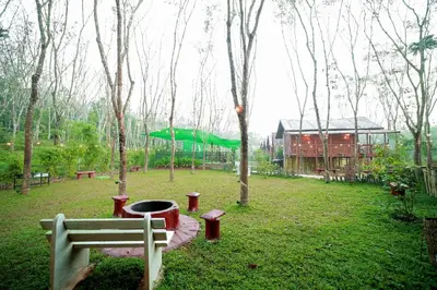 a park with a bench and a green slide at Bali bamboo in Padinjarathara