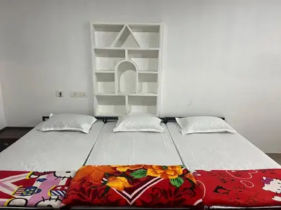 a large bed in a room with two pillows at Pookode Service Villa in Vythiri