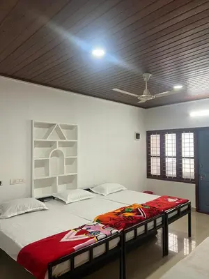a bedroom with a large bed in a room at Pookode Service Villa in Vythiri