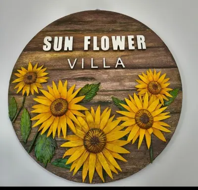 a sign with sunflowers on it with the words sunflower village at Sunflower Villa Cottage Coonoor in Coonoor