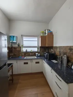 a kitchen with a sink and a counter top at Sunflower Villa Cottage Coonoor in Coonoor