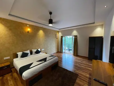 a bedroom with a king sized bed in a room at Nellarachal Homestay in Ambalavayal