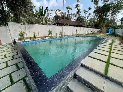 a swimming pool with turquoise water at Nellarachal Homestay in Ambalavayal