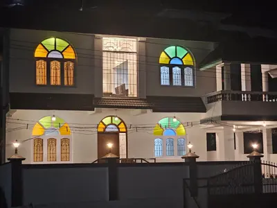 a building with colorful stained glass windows at night at Hestia chalet 3BHK near Ooty lake in Ooty