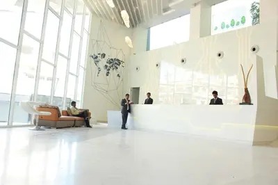 a group of people standing in a lobby at Hotel Vijay Elanza in Coimbatore