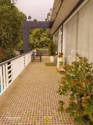 an outdoor walkway with a bench on a house at Viharana Spa and Resorts in Ooty