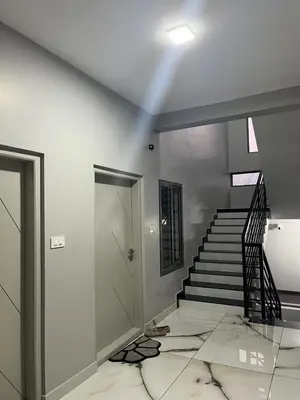 a room with a staircase and a stair case at Serenity Homes near Rajagiri Hospital in Alwaye