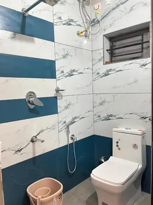 a bathroom with a toilet and a shower at Serenity Homes near Rajagiri Hospital in Alwaye
