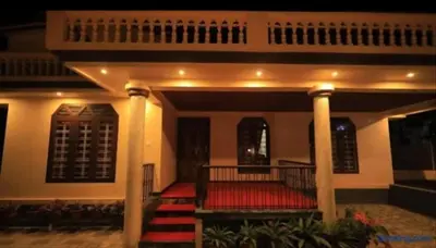 a house with a red carpet on the porch at Hamai town villa in Ambalavayal