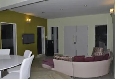 a living room with a couch and a table at Palazzo Villa in Ooty