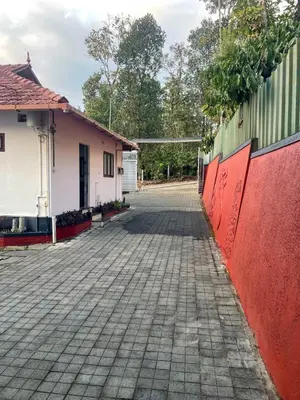 an empty driveway in front of a house at Edakkal Pool Villa in Ambalavayal