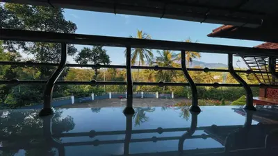 a view of a swimming pool through a window at Pepper Valley Resort in Kalpetta