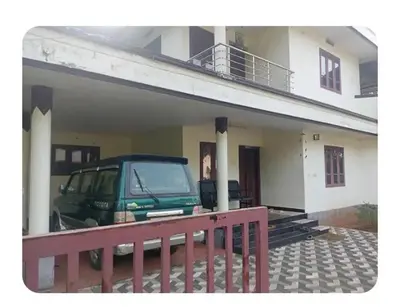 a green van parked in front of a house at Dream Home in Irimbranallūr