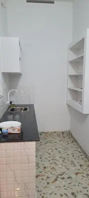 a kitchen with a sink and a counter top at Krishna stays in Manattala