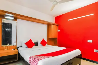 a red room with a bed with a red wall at Super Hotel O By OYO Maruthi Gandhi Park in Coimbatore