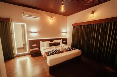a bedroom with a large bed in a room at Manayath Wayanad Premium Pool Resort in Wayanad