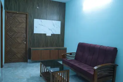 a living room with a purple couch and a door at Thulir Homestay Valparai in Vālpārai