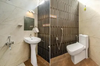 a bathroom with a toilet and a sink at White Meadows Mysore in Mysore