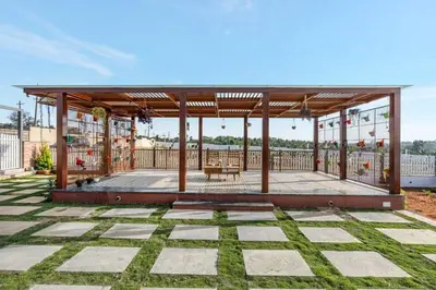 a pavilion with a table and chairs on a patio at White Meadows Mysore in Mysore