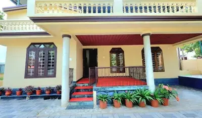 a house with a staircase in front of it at Hamai town villa in Ambalavayal