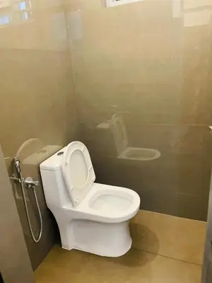 a bathroom with a toilet and a sink at Silver Gate Rooms in Kozhikode