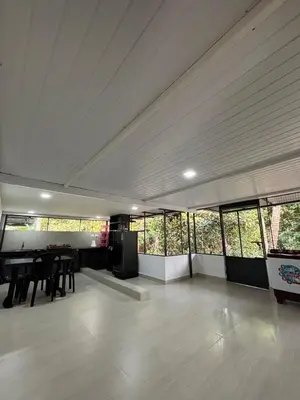 a large room with a table and some windows at Sawan Homestay in Tāzhekkod