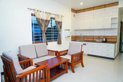 a kitchen with a couch and a table and chairs at Nature'call homestay in Ooty