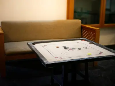 a table with scissors on it next to a couch at Wayanad Pent House in Mananthavady
